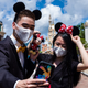 Visitors take a selfie at Hong Kong Disneyland on June 18, 2020.